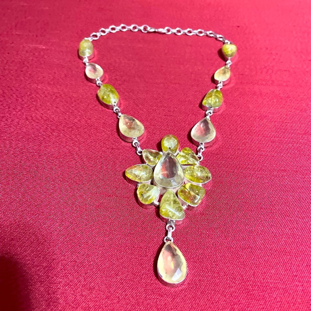 I think it prehnite crystal.  I thought it was peridot.  Sterling silver chain.